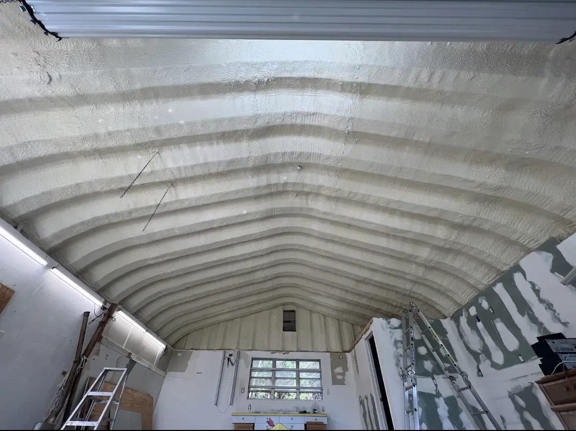 Spray polyurethane foam applied to the underside of a metal roof deck in Riverdale